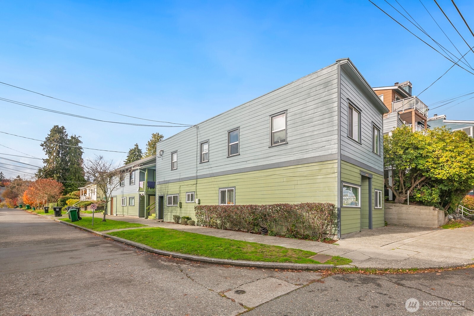 7103 Linden Avenue North, Unit 15 Seattle, WA 98103 - Photo 8 of 40 a front view of a house with a yard and garage