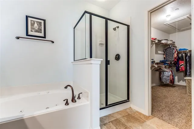 a bathroom with a bathtub and a shower