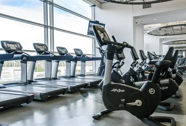 an aerial view of a tennis ground and a houses