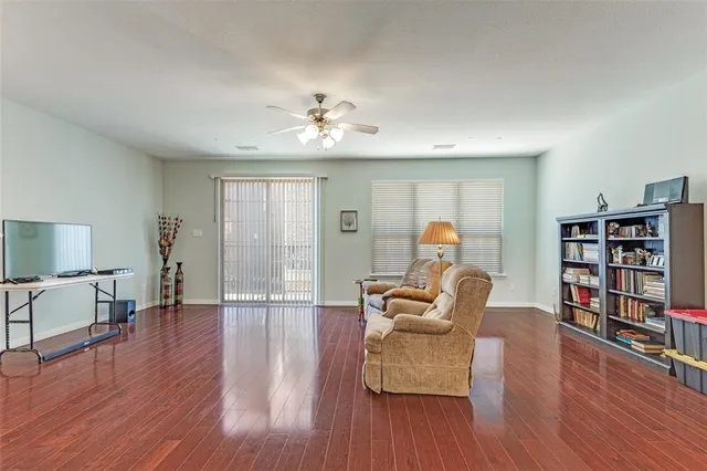 a living room with furniture and a wooden floor