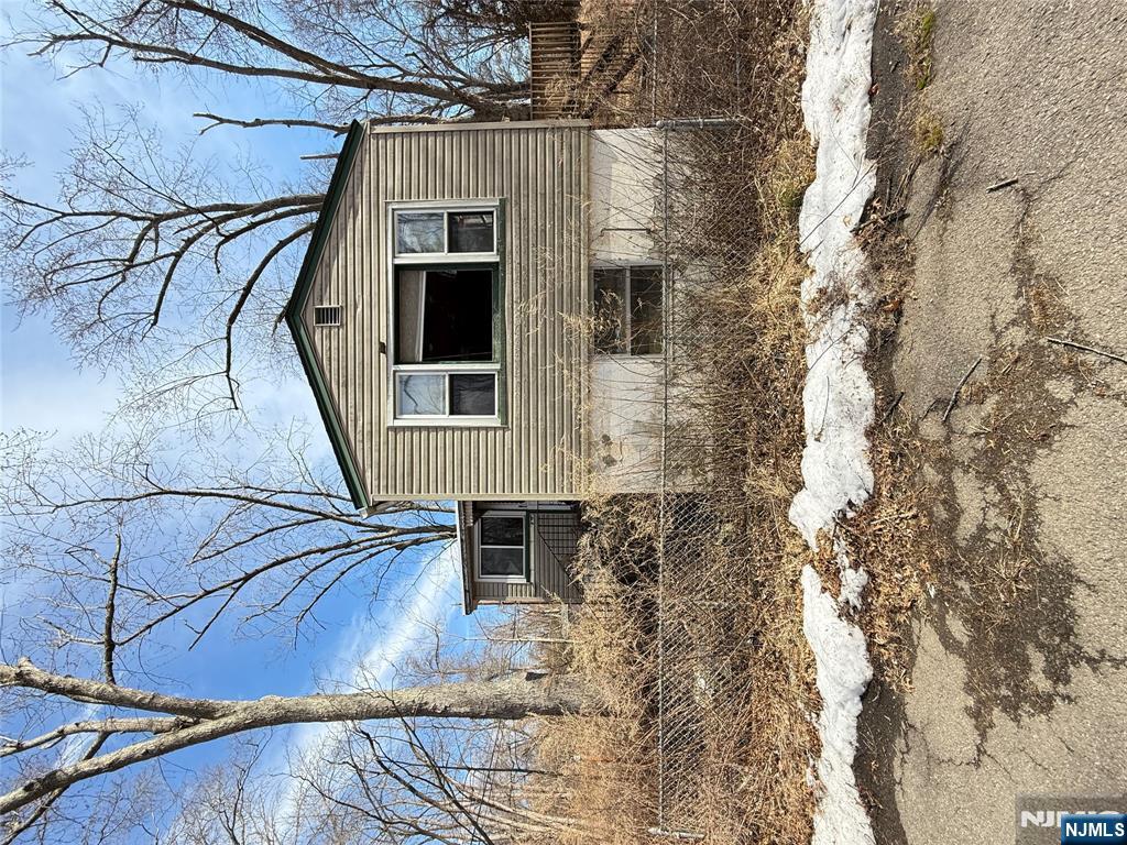 2 Brookside Road Wayne, NJ 07470 - Photo 2 of 2 a front view of a house with yard covered in snow