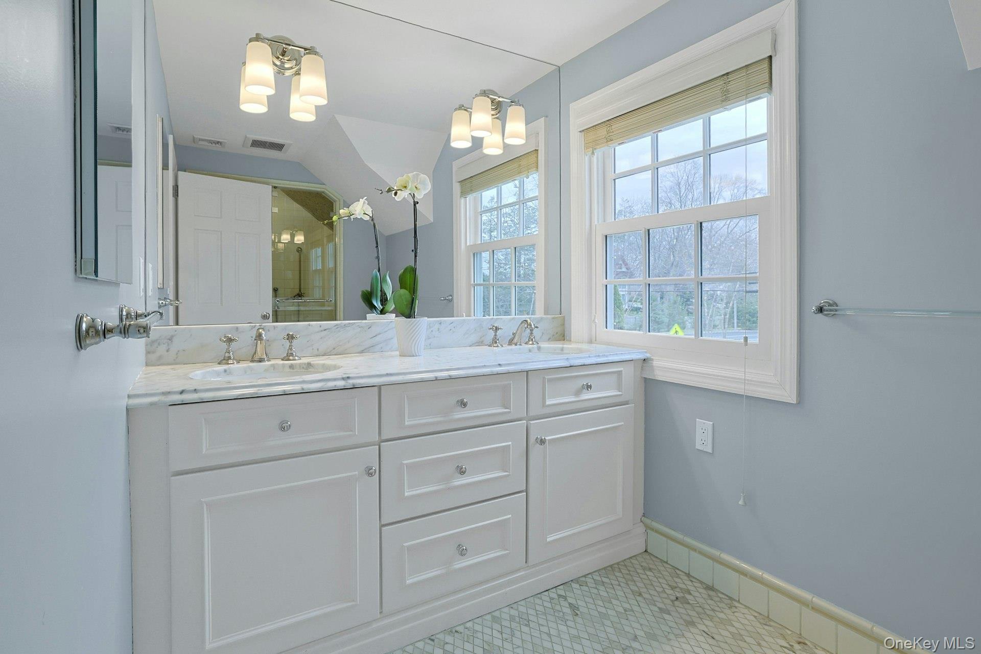 250 Mamaroneck Road Scarsdale, NY 10583 - Photo 19 of 35 Stunning and beautifully designed, the marble ensuite primary bath offers custom built-in cabinetry with double vanity and glass enclosed steam shower (pictured next).