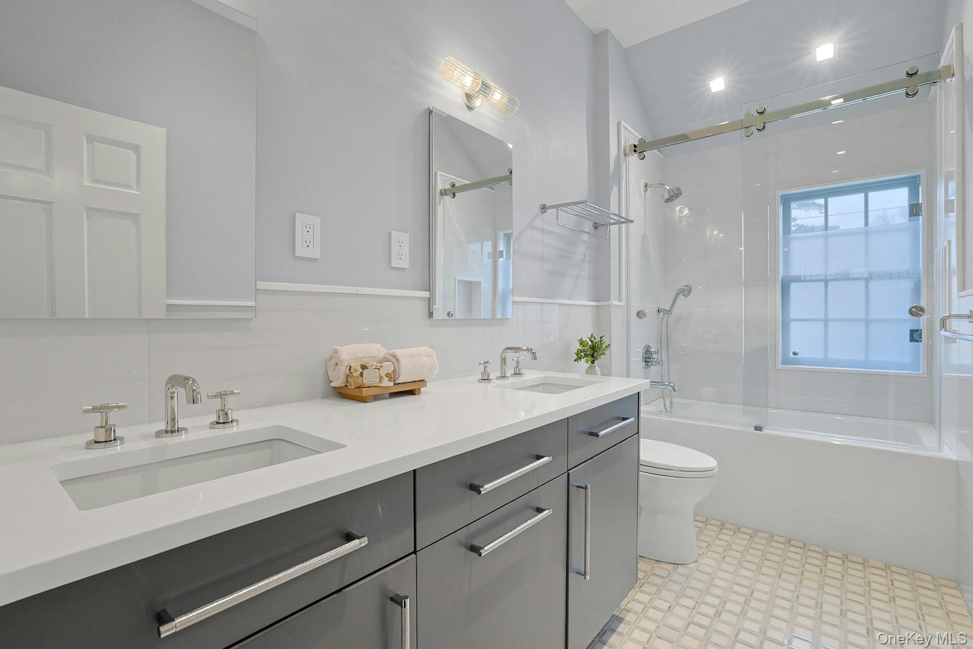 250 Mamaroneck Road Scarsdale, NY 10583 - Photo 25 of 35 Hall bath, upgraded in 2025 with double vanity and glass-enclosed shower/tub.
