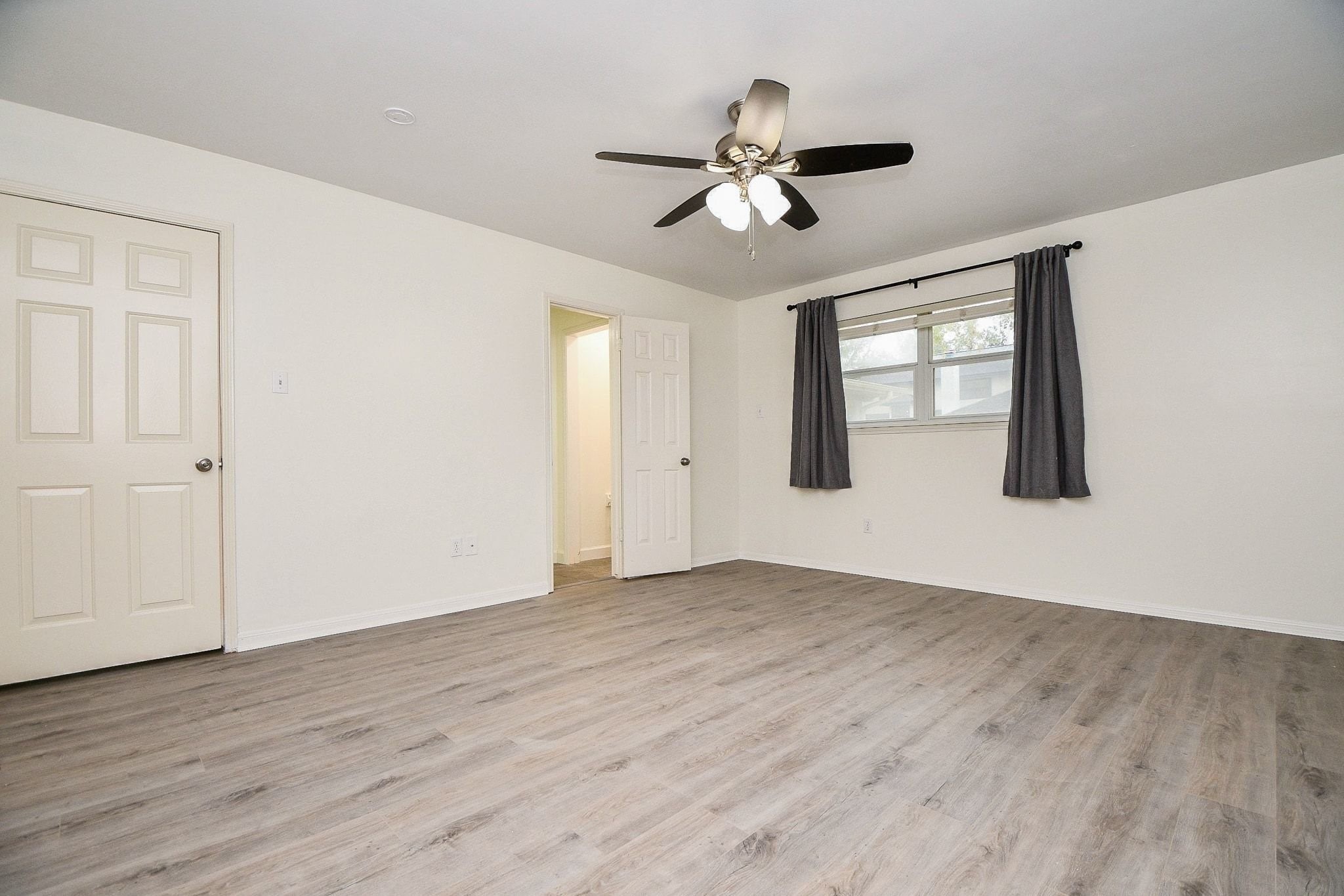 14011 Wickersham Lane Houston, TX 77077 - Photo 21 of 38 The primary bedroom suite overlooks the backyard and is complete with a freshly remodeled bathroom and large walk-in closet.