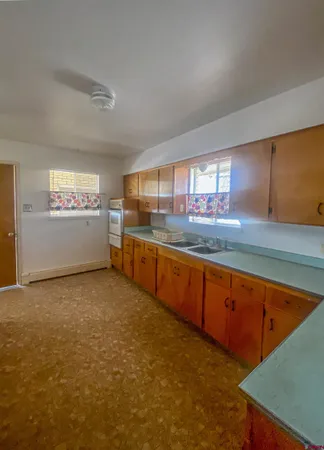 a large kitchen with stainless steel appliances granite countertop a sink and cabinets