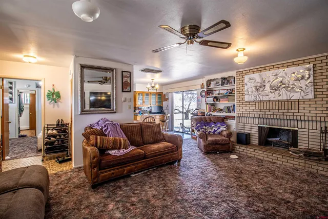 a living room with fireplace furniture and a fireplace