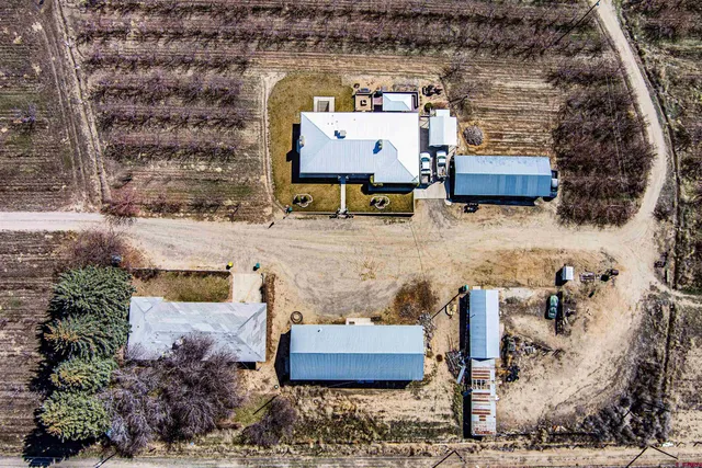an aerial view of a house with a yard