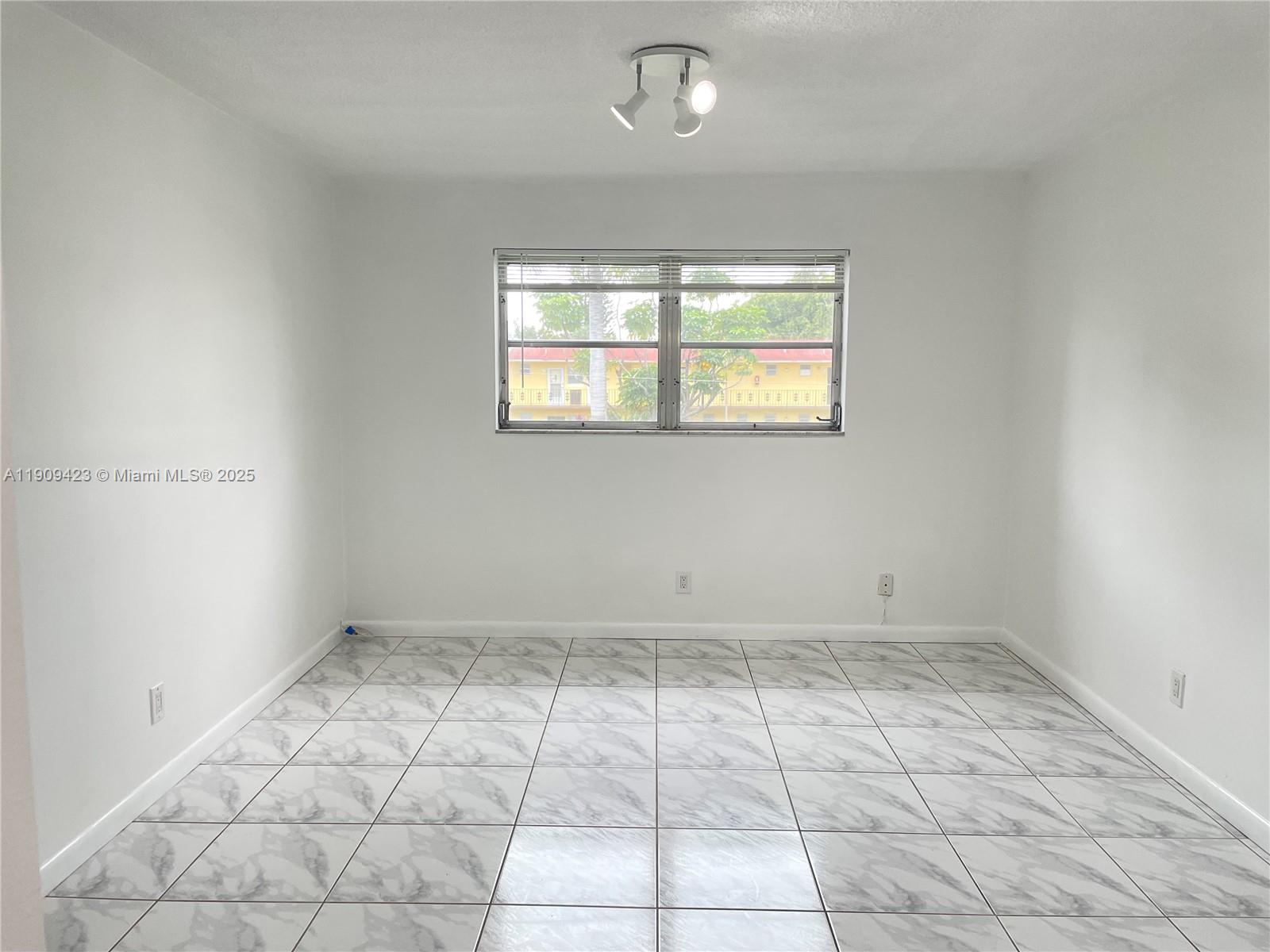 20201 Northeast 29th Court, Unit D221 Aventura, FL 33180 - Photo 10 of 13 an empty room with white walls and tiles