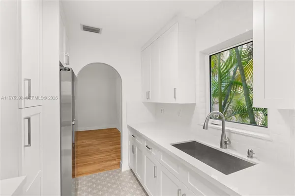 a kitchen with a sink and a refrigerator