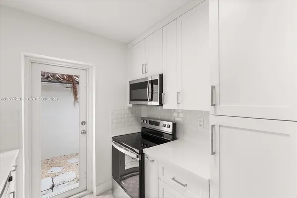 a kitchen with a refrigerator stove and a sink