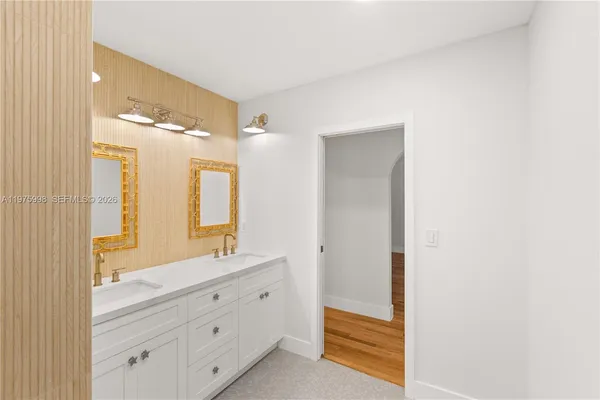a bathroom with a double vanity sink mirror and double