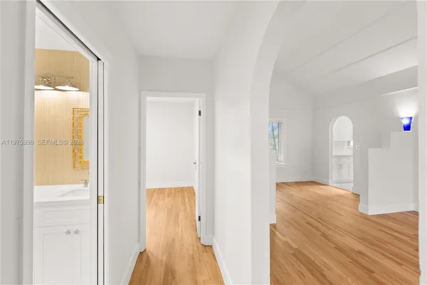 a view of hallway with wooden floor