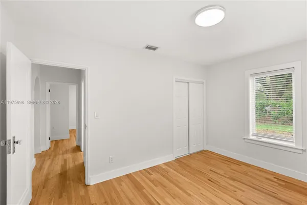 a view of a room with wooden floor and window