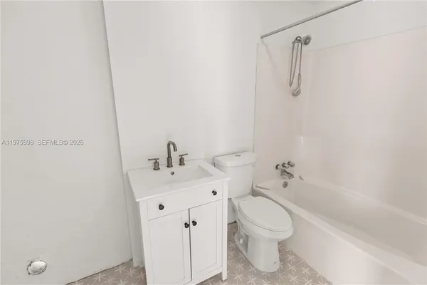 a bathroom with a toilet a sink and a bathtub