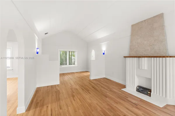 a view of wooden floor and windows in a room