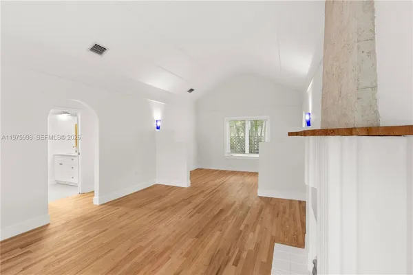 a view of a room with wooden floor and cabinet