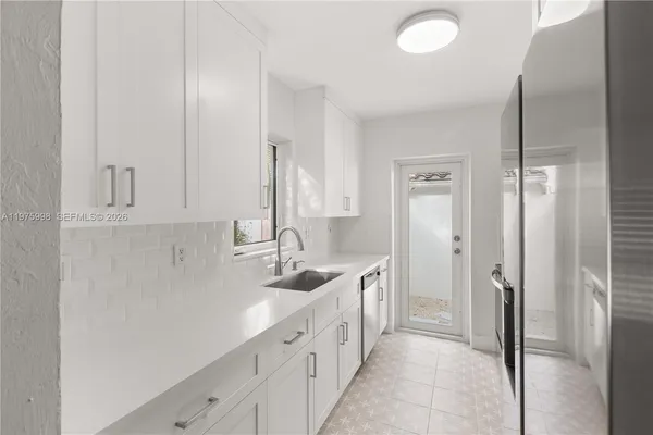 a spacious bathroom with a double vanity sink a mirror and a shower