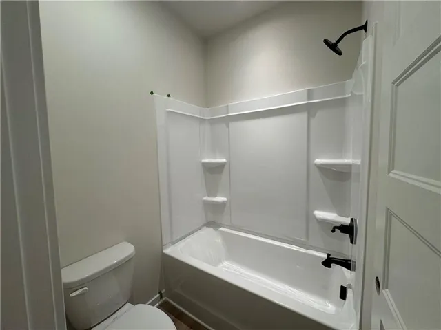 a bathroom with a bathtub and a toilet