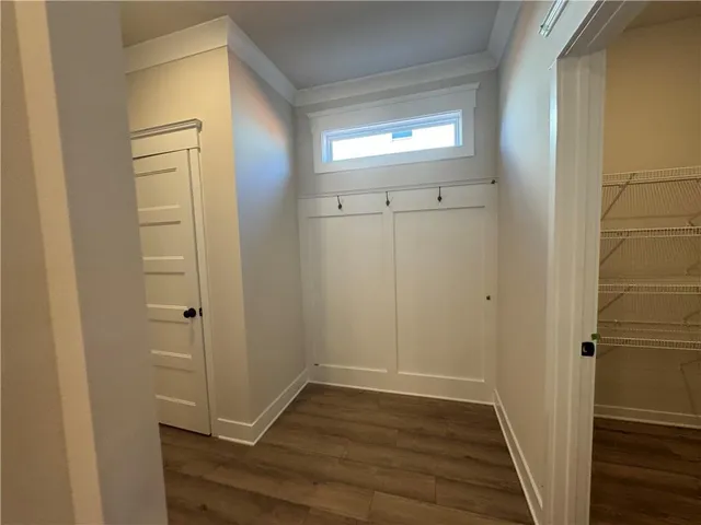a view of empty room with wooden floor