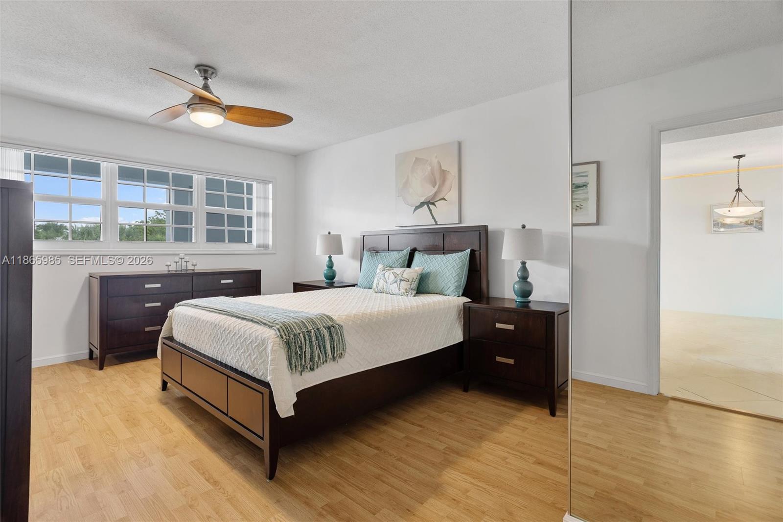 3150 North Course Lane, Unit 402 Pompano Beach, FL 33069 - Photo 14 of 29 a bedroom with a bed and window