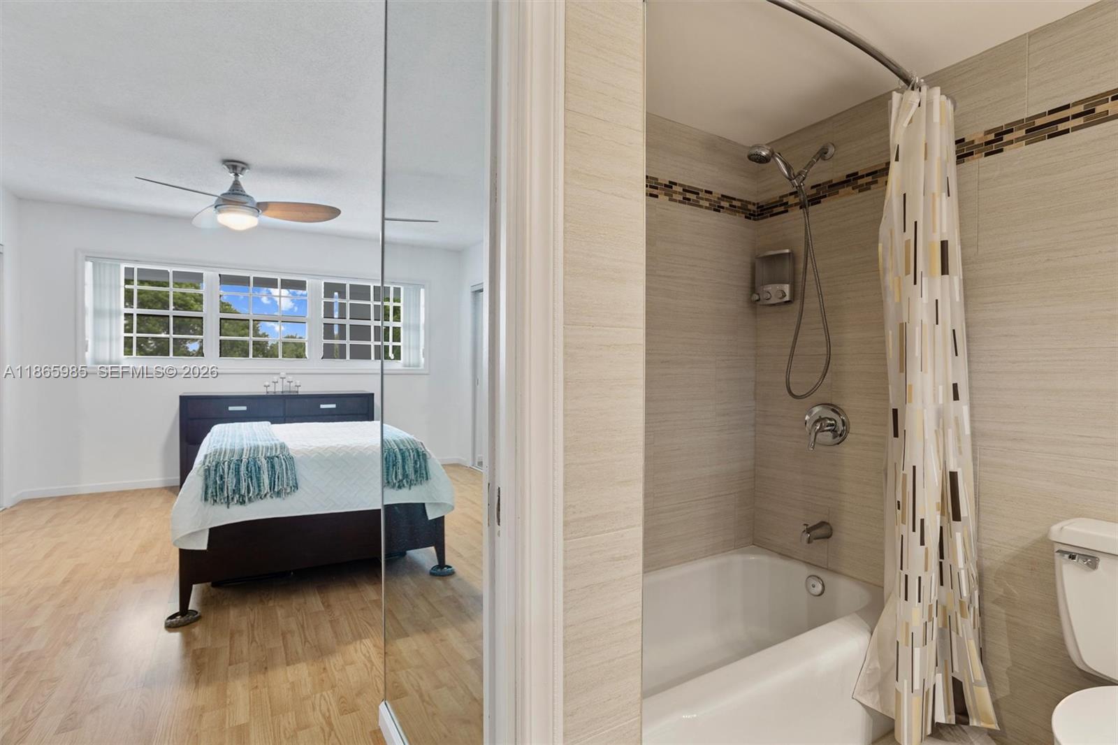 3150 North Course Lane, Unit 402 Pompano Beach, FL 33069 - Photo 15 of 29 a bedroom with a bed and a window