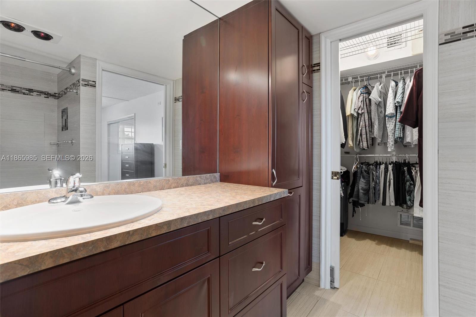 3150 North Course Lane, Unit 402 Pompano Beach, FL 33069 - Photo 17 of 29 a bathroom with a sink double vanity and a mirror