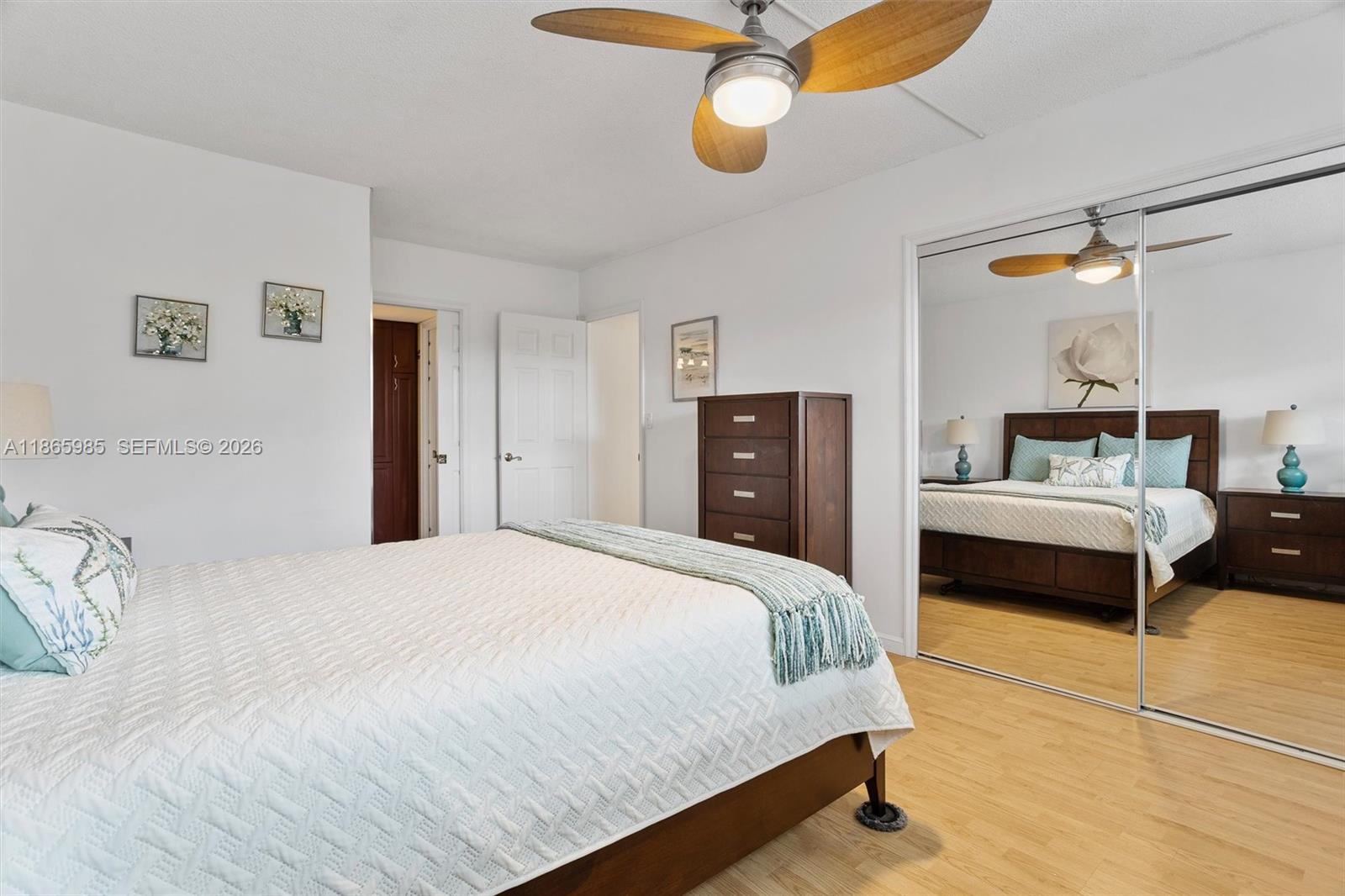 3150 North Course Lane, Unit 402 Pompano Beach, FL 33069 - Photo 18 of 29 a bedroom with a bed and dresser