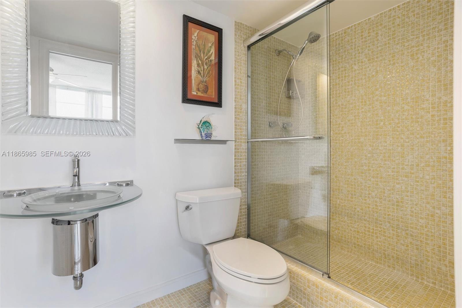 3150 North Course Lane, Unit 402 Pompano Beach, FL 33069 - Photo 20 of 29 a bathroom with a sink toilet and shower