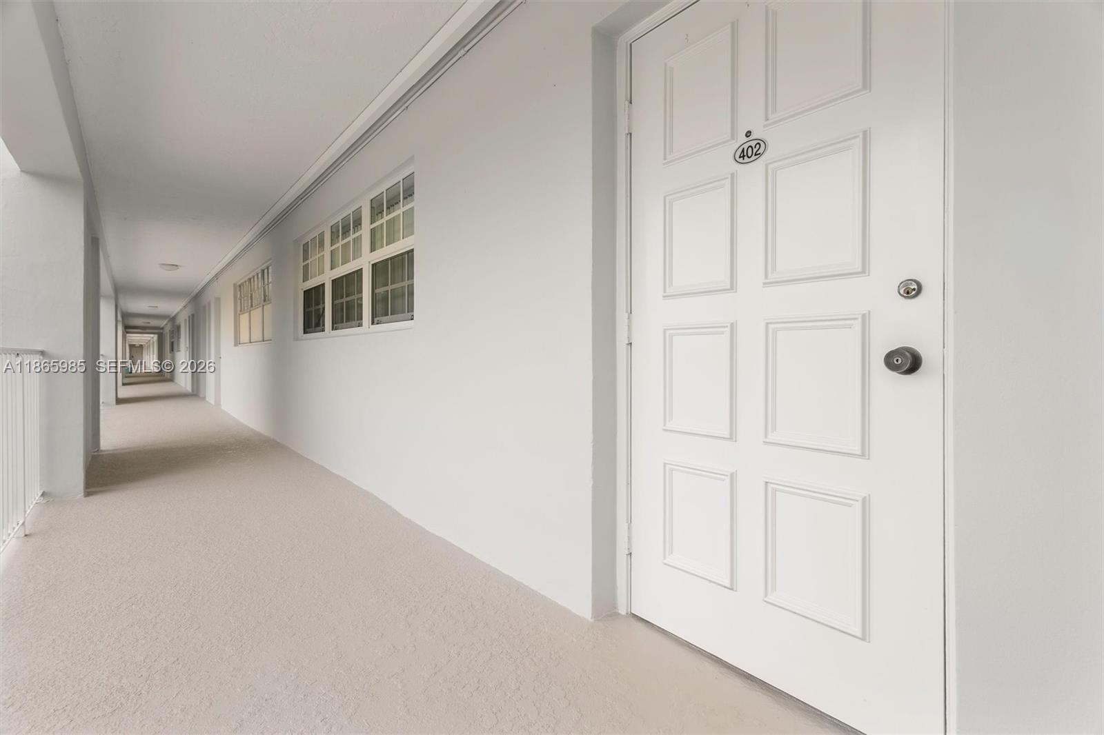 3150 North Course Lane, Unit 402 Pompano Beach, FL 33069 - Photo 21 of 29 an empty room with windows