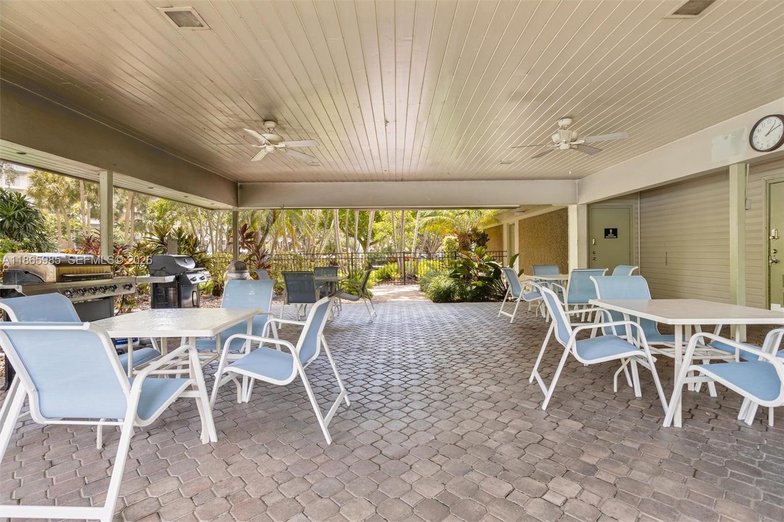 3150 North Course Lane, Unit 402 Pompano Beach, FL 33069 - Photo 27 of 29 a dining room with furniture a rug and a large window