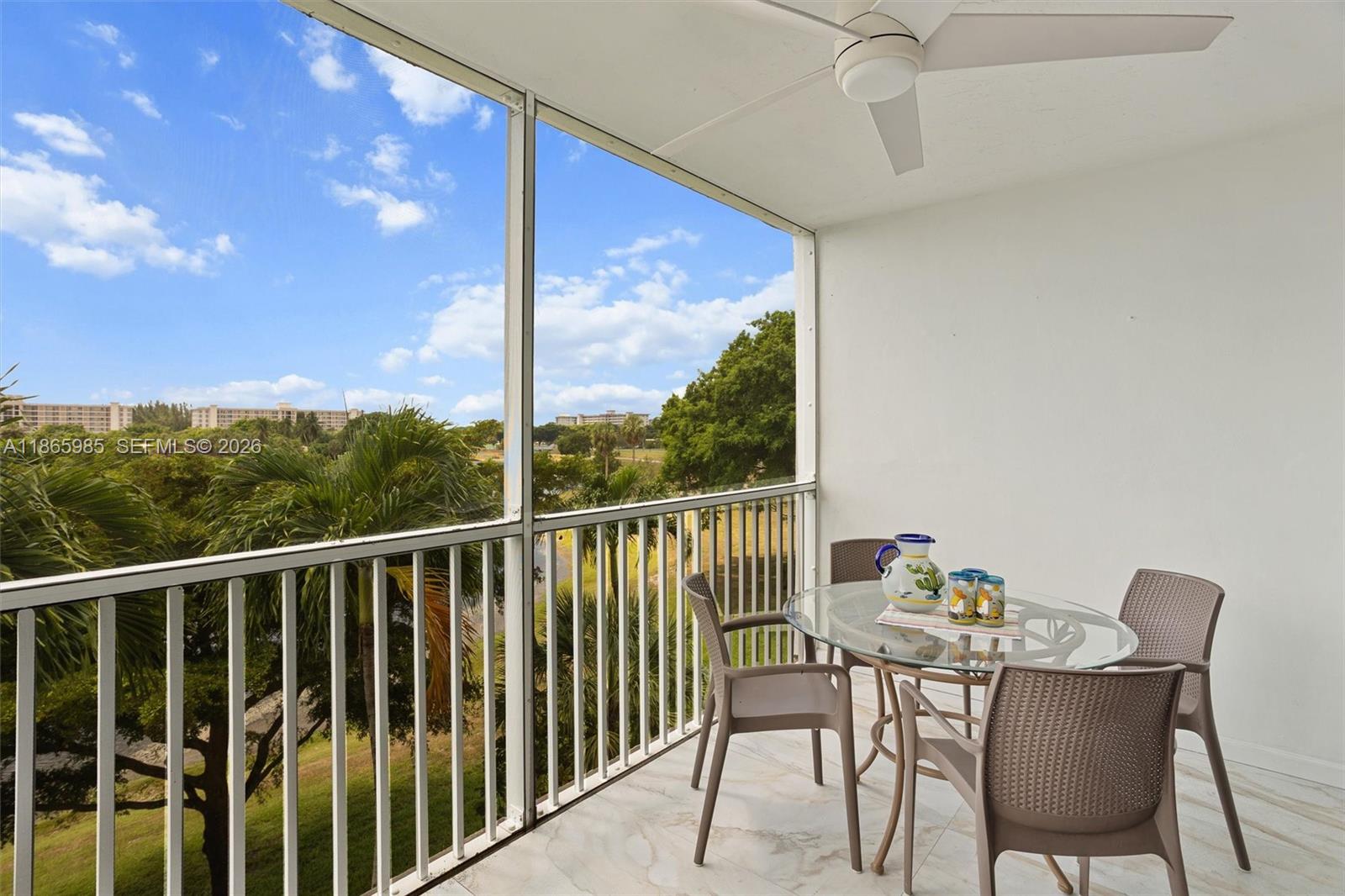 3150 North Course Lane, Unit 402 Pompano Beach, FL 33069 - Photo 6 of 29 a view of a chair and table in the balcony