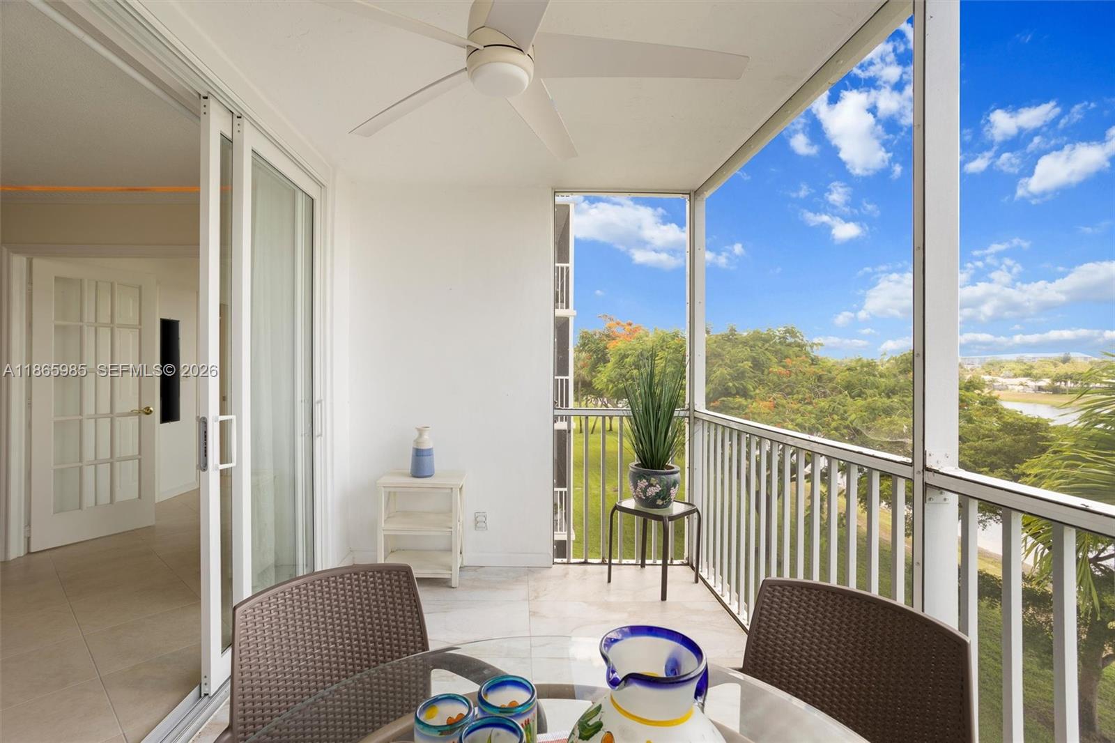 3150 North Course Lane, Unit 402 Pompano Beach, FL 33069 - Photo 8 of 29 a view of a dining room with furniture window and wooden floor