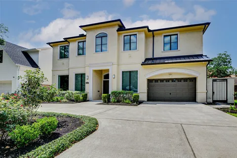 a front view of a house with yard and parking