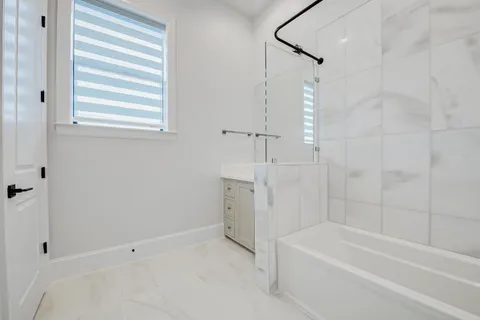 a bathroom with a bathtub and shower