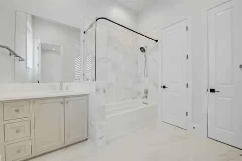 a bathroom with a granite countertop sink a toilet and a bathtub