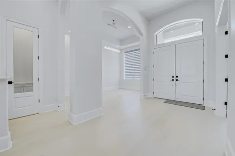 an empty room with a windows and closet
