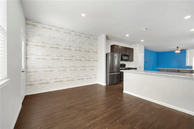 a view of kitchen view with wooden floor and stainless steel appliances