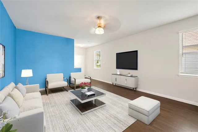 a living room with furniture and a flat screen tv