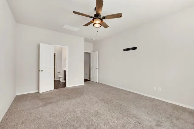 a view of a livingroom with a ceiling fan and window