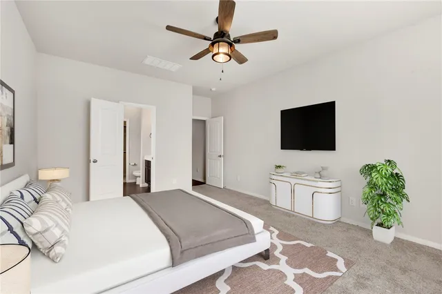 a bedroom with a bed and a flat screen tv