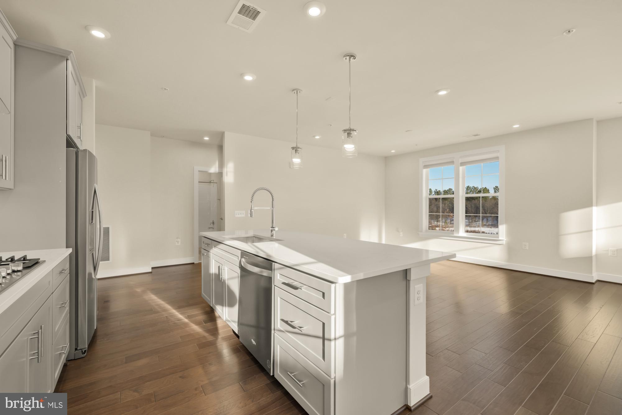 2320 Field Point Road, Unit 4304 Herndon, VA 20171 - Photo 13 of 43 a kitchen with a sink stove and wooden floor