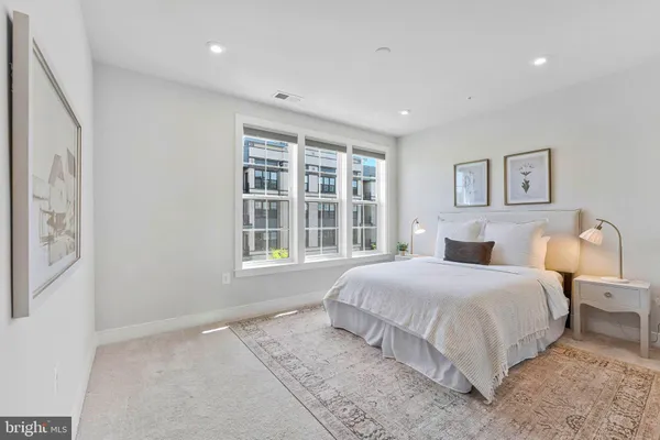a bedroom with a large bed and a window