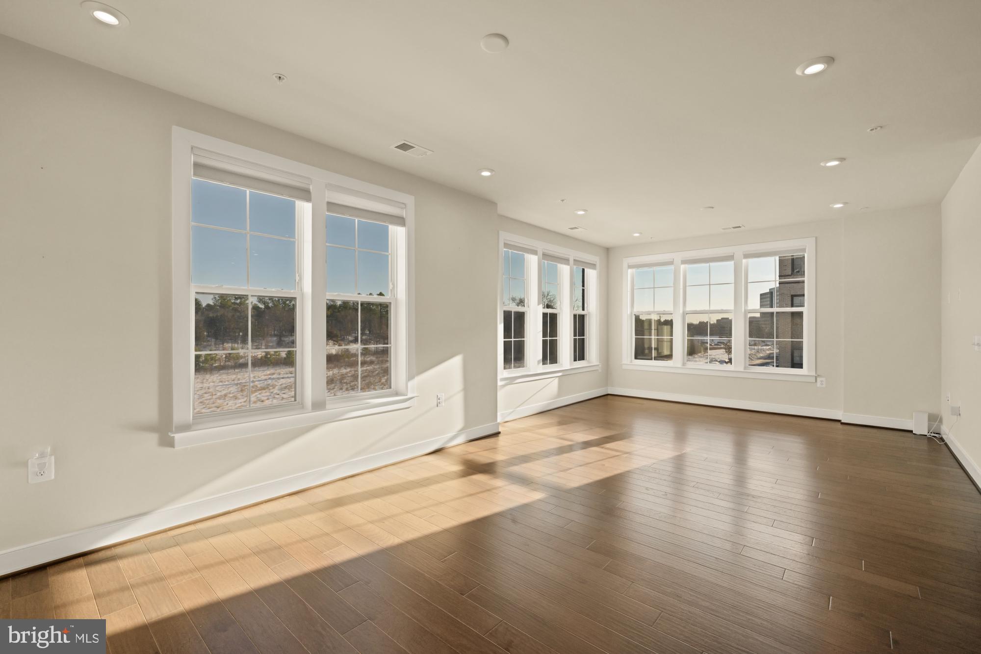 2320 Field Point Road, Unit 4304 Herndon, VA 20171 - Photo 14 of 43 a view of an empty room with a window and wooden floor