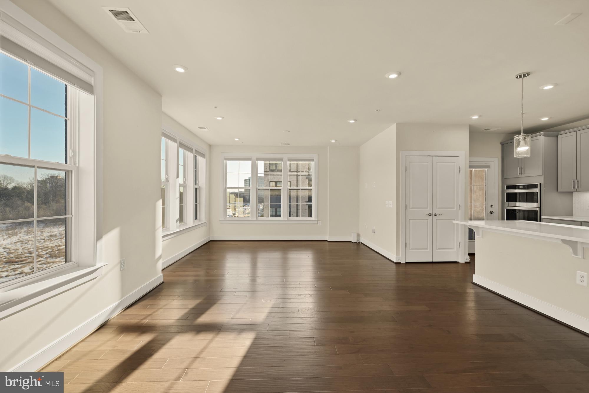 2320 Field Point Road, Unit 4304 Herndon, VA 20171 - Photo 15 of 43 a view of an empty room with wooden floor and a window