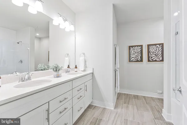 a bathroom with a double vanity sink and mirror