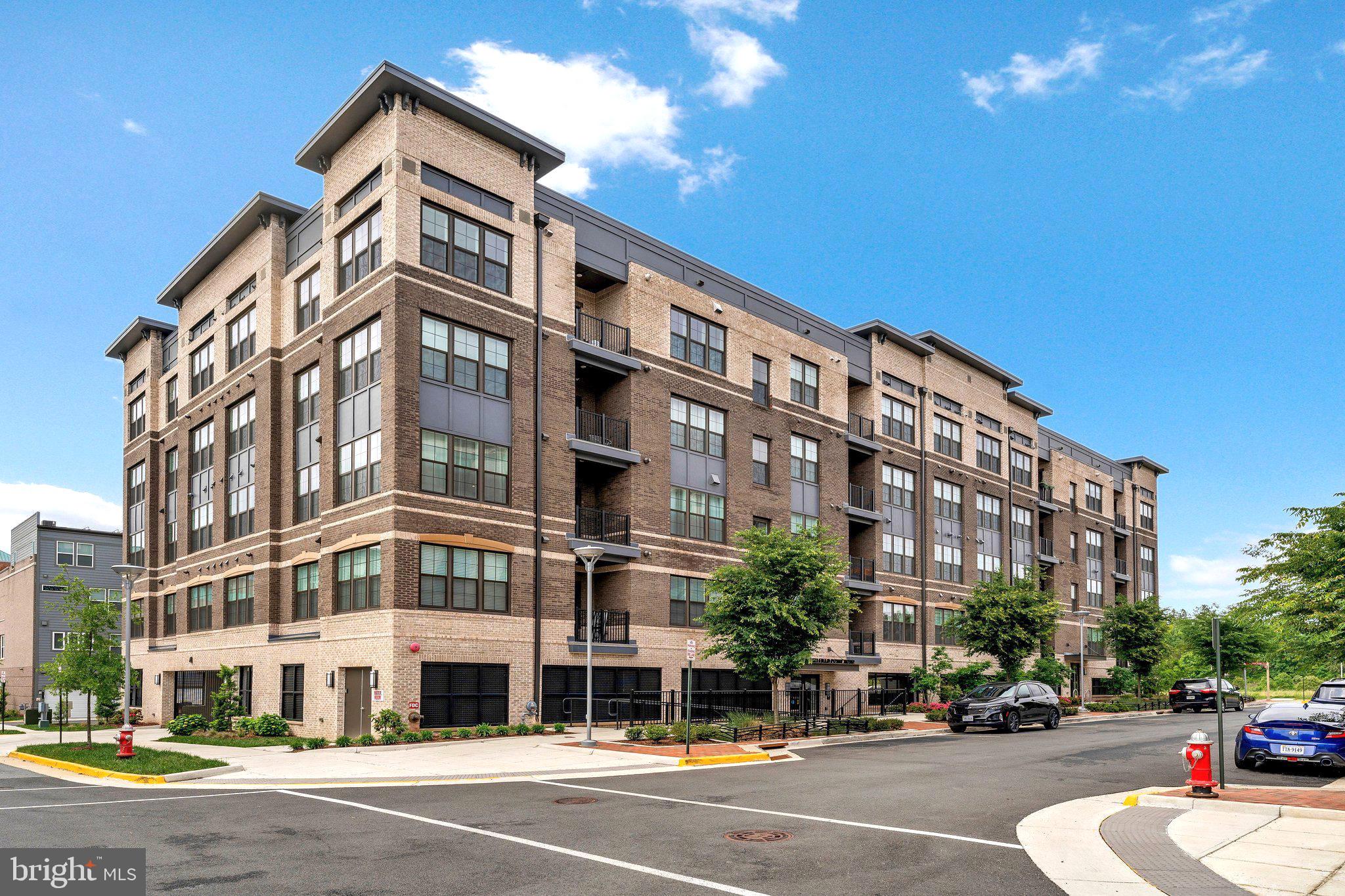 2320 Field Point Road, Unit 4304 Herndon, VA 20171 - Photo 23 of 42 a city street lined with buildings and cars parked on the street
