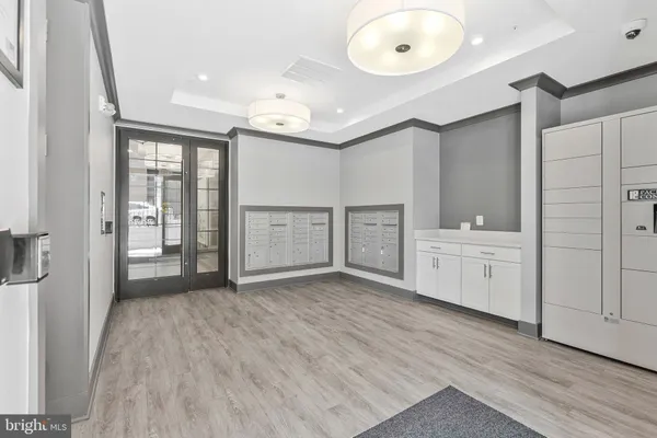 a view of a kitchen with white cabinets and wooden floor