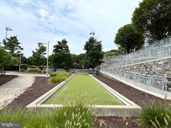 a view of a pathway with a wrought fence