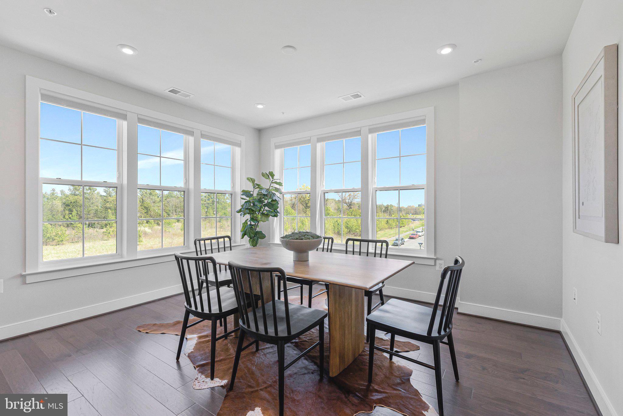 2320 Field Point Road, Unit 4304 Herndon, VA 20171 - Photo 6 of 42 a view of a dining room with furniture and wooden floor