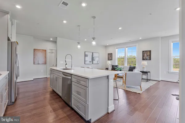a kitchen with counter top space and wooden floor